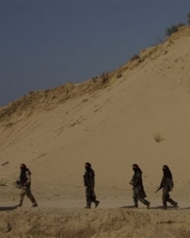 Women soldiers in hijab crossing remote landscape